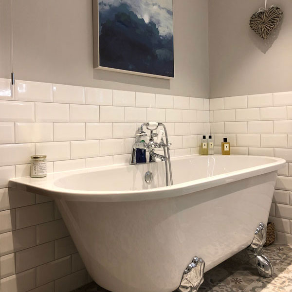 Bath and tiled wall at Chester property