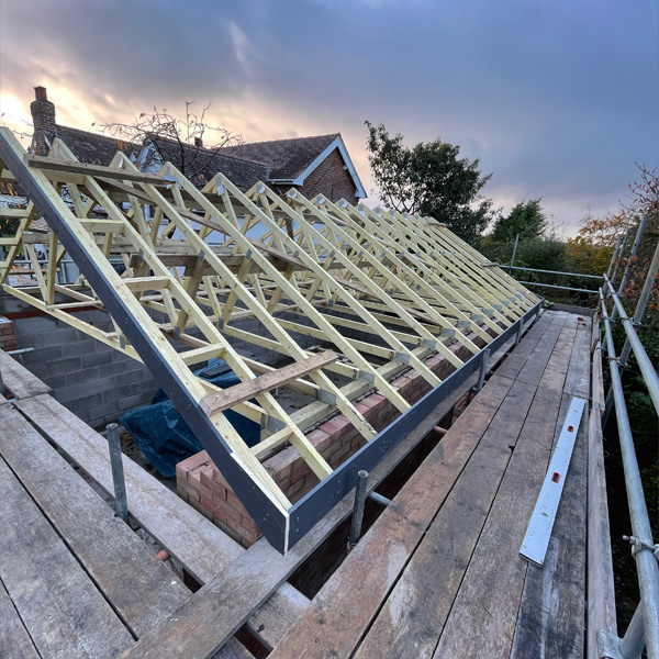 Housign extension roof being built